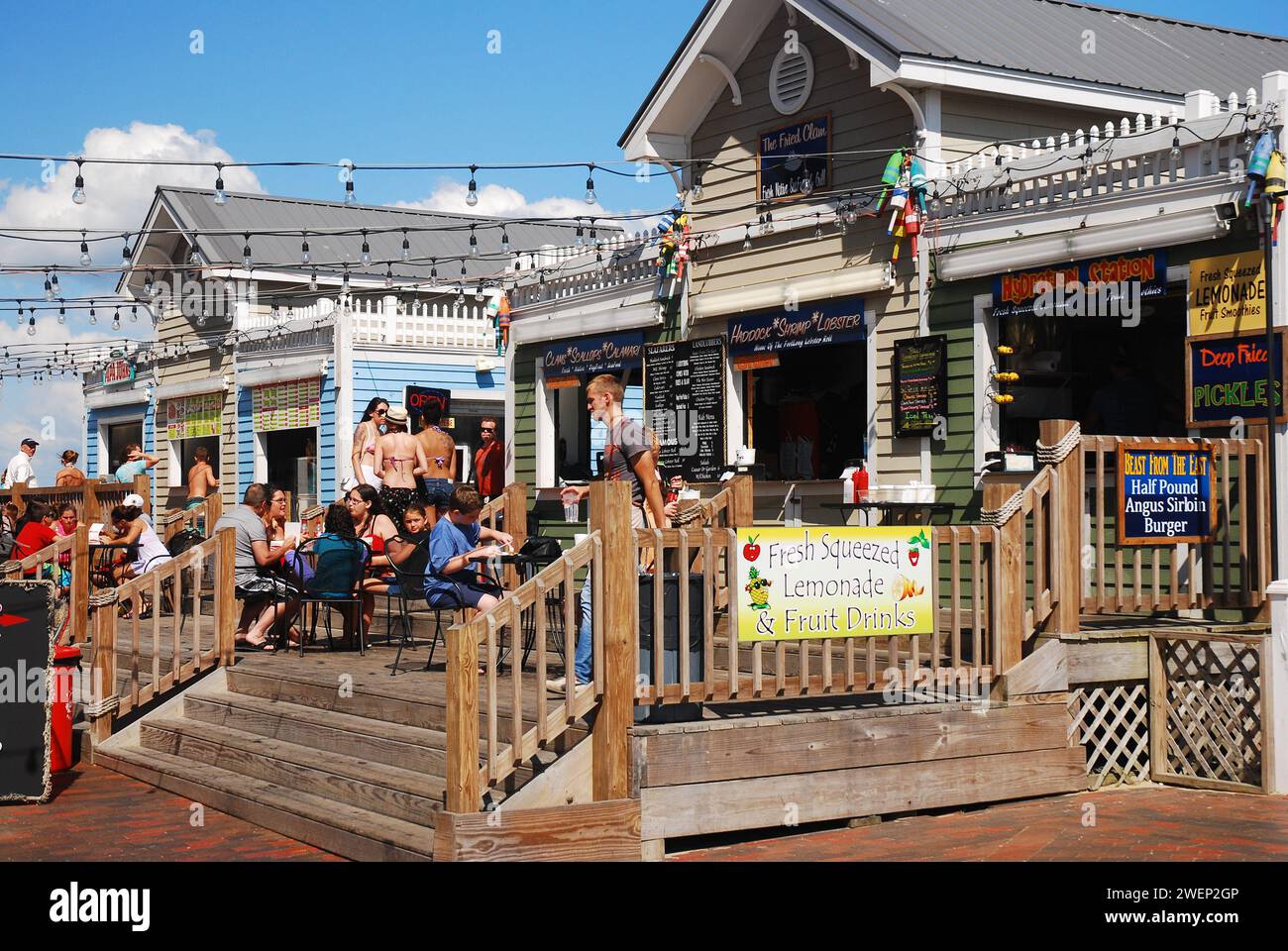 A crowd of people enjoy lunch on a summer vacation day at an outdoor cafe in Old Orchard Beach, Maine Stock Photo