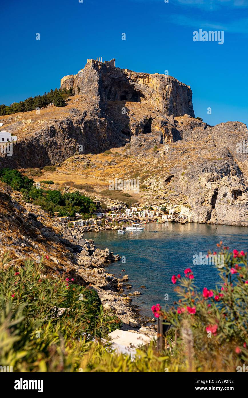 the-acropolis-of-lindos-and-the-beach-in-st-paul-s-bay-in-rhodes-stock