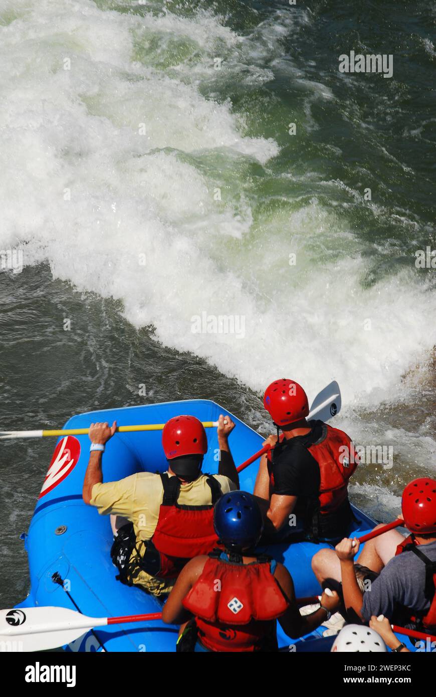 A group of adventure seekers prepare themselves for a drop into the rapids at the Whitewater Rafting Center in Charlotte, North Carolina Stock Photo