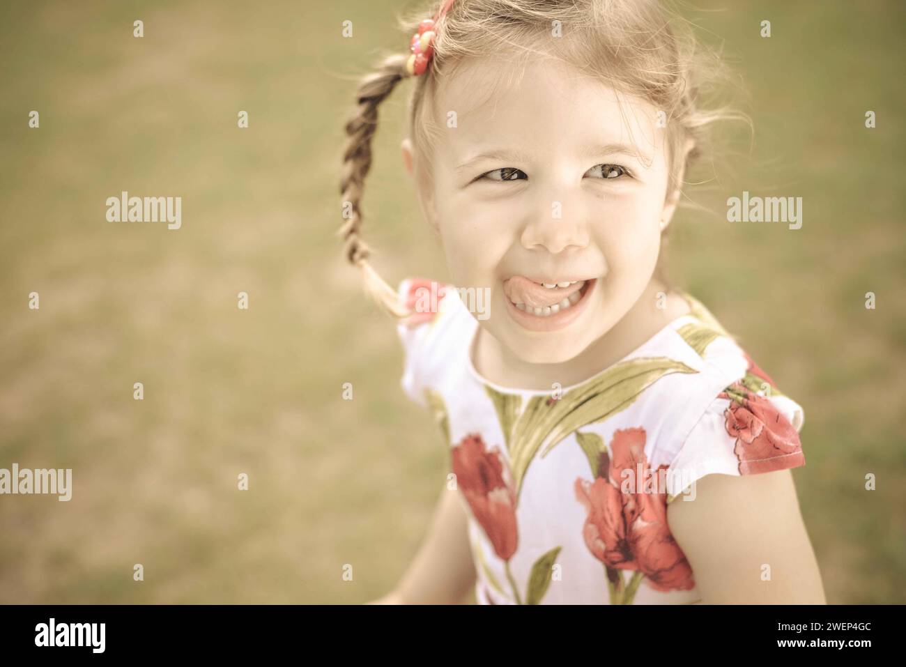 Little girl playing outside portrait Stock Photo - Alamy