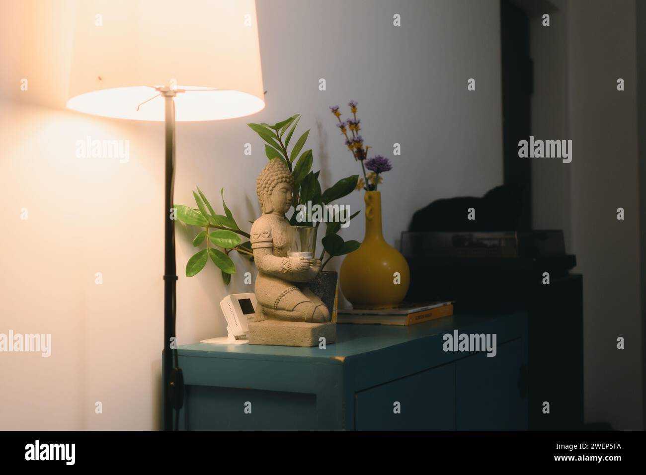 A table lamp and a decorative vase on a side table Stock Photo