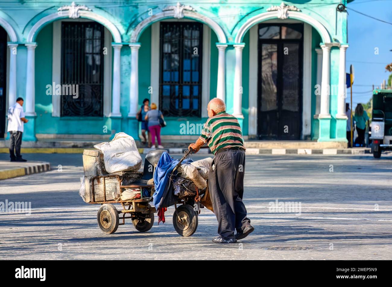 senior man pushing car, santa clara, cuba Stock Photo