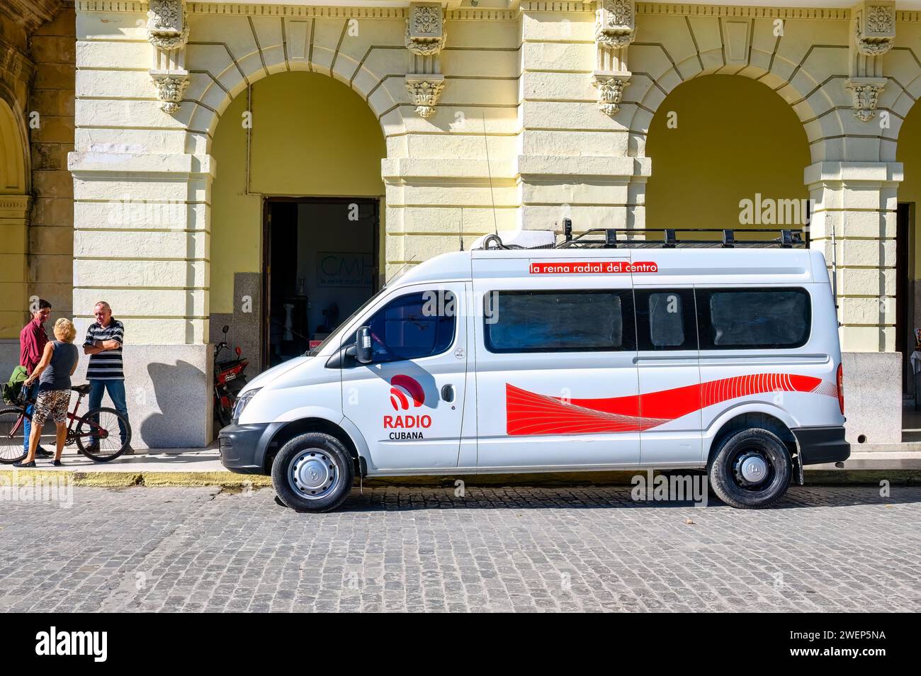 van vehicle cmhw radio station with logo in front of building, santa ...