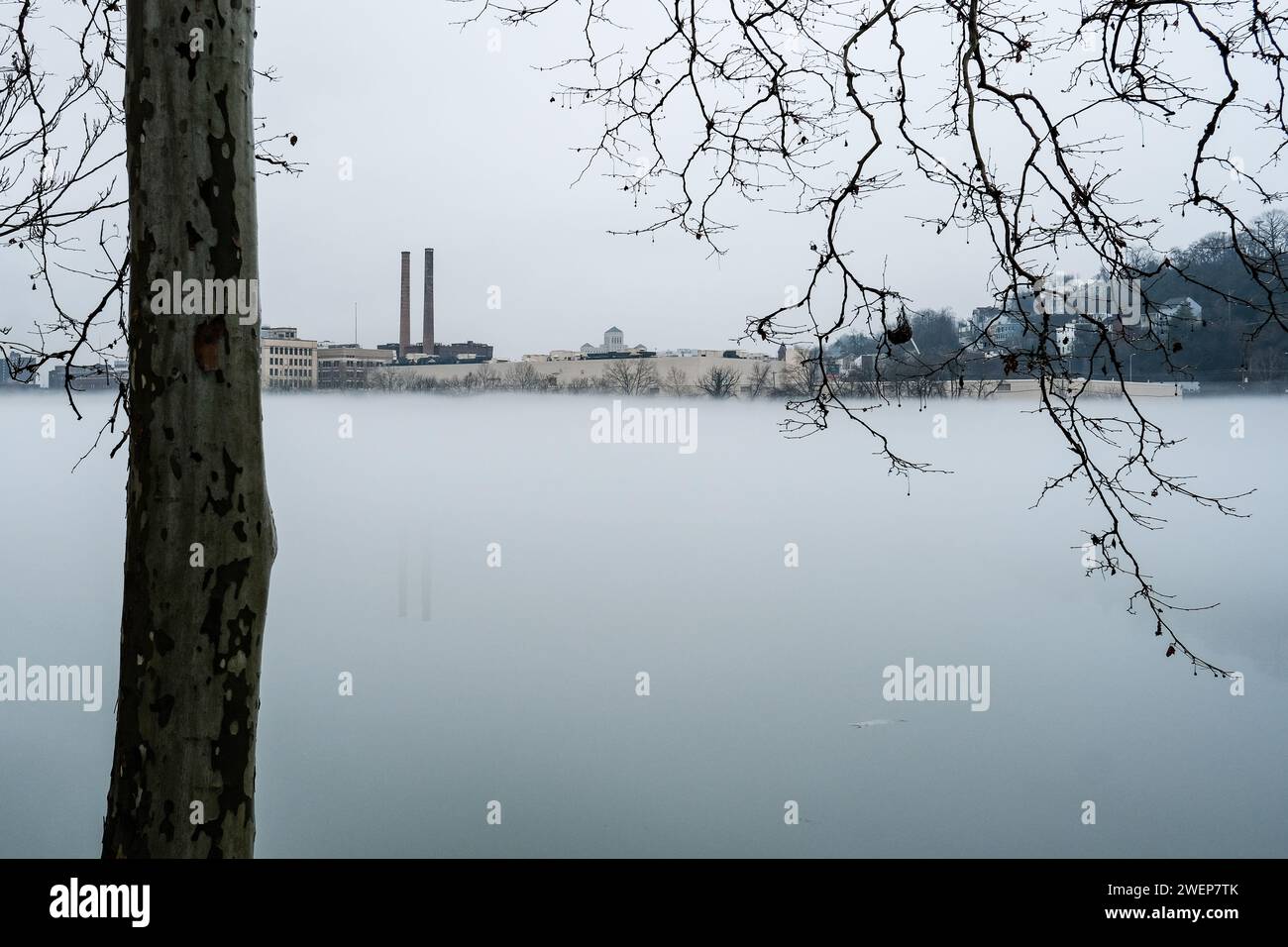 Morning fog on the Allegheny River. The Heinz smokestacks are visible in the background. Stock Photo