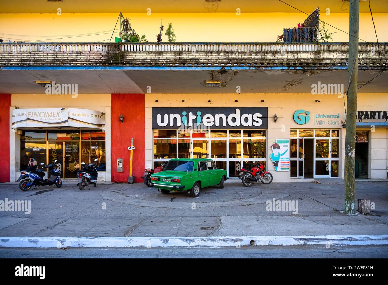car in front of unitiendas business, santa clara city, cuba, 2024 Stock Photo