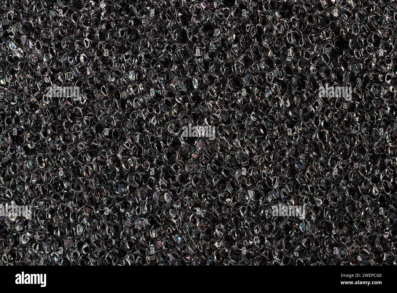 Foam rubber texture close up. High quality macro texture of dark grey foam rubber sponge. Stock Photo