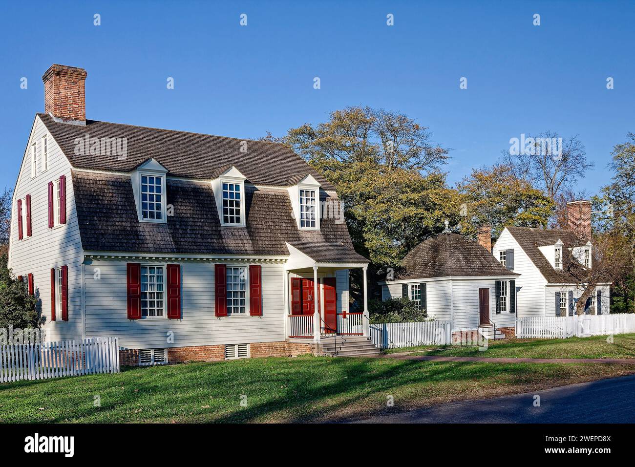 3 houses, close together, white, shutters, chimneys, dormer windows