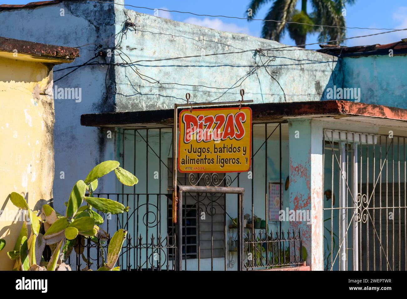 Pizzeria sign in weathered house, Santa Clara, Cuba Stock Photo