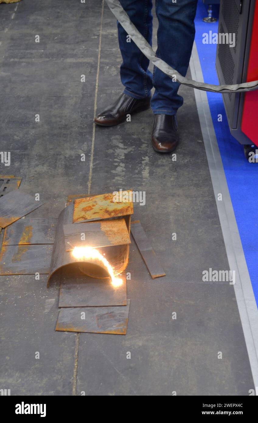 Laser cleaning of metal. The laser beam cleans the metal surface from