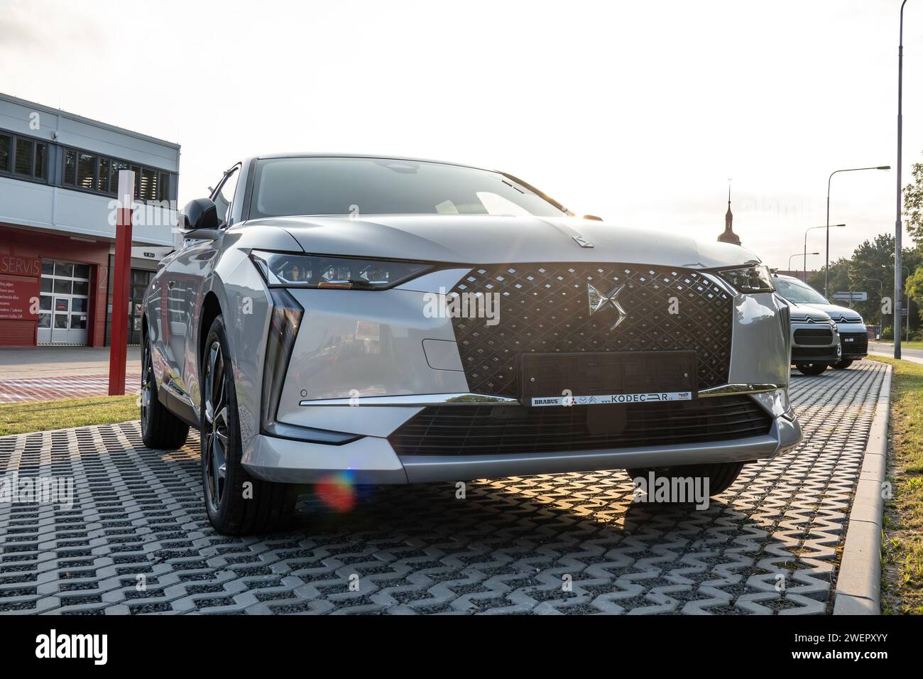 OSTRAVA, CZECH REPUBLIC - AUGUST 23, 2023: French DS 4 hatchback car presented at dealership with lens flare at sunset Stock Photo