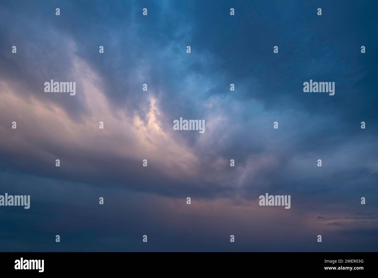 Dramatic pastel colored clouds at sunset. Cloudscape photo. Stock Photo
