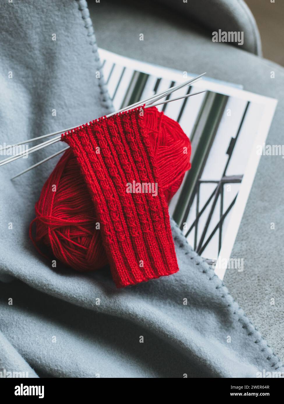 Hand knitted socks with needles and yarn ball. Concept for handmade and hygge slow life. Stock Photo