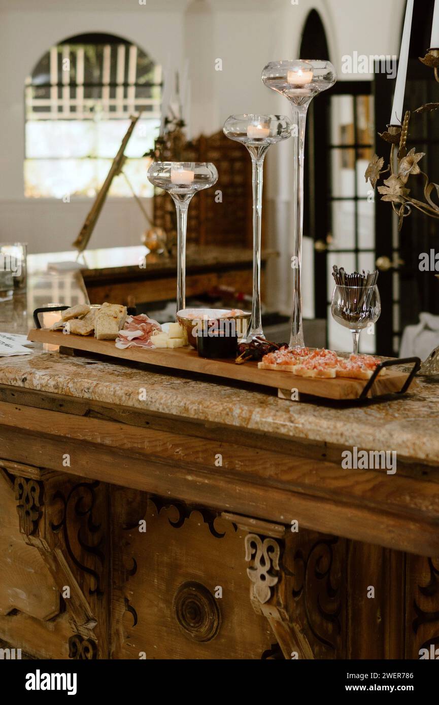 A sampler board with an assortment of glasses, delectable cookies, and delectable appetizers at the bar Stock Photo