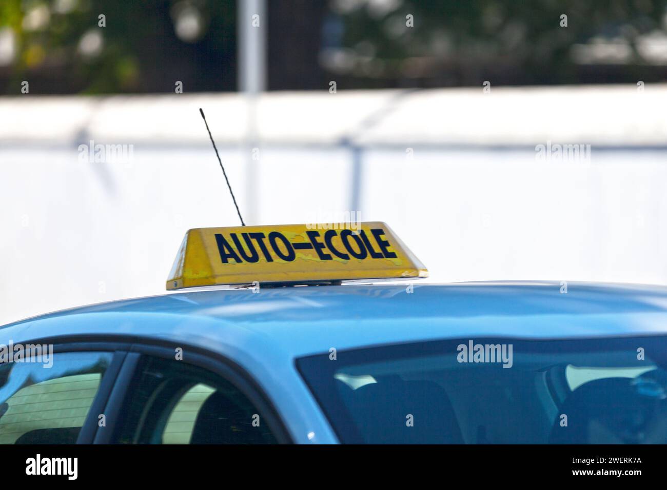 Yellow car roof sign with written in it in French 'Auto-Ecole', meaning in English 'Driving school'. Stock Photo