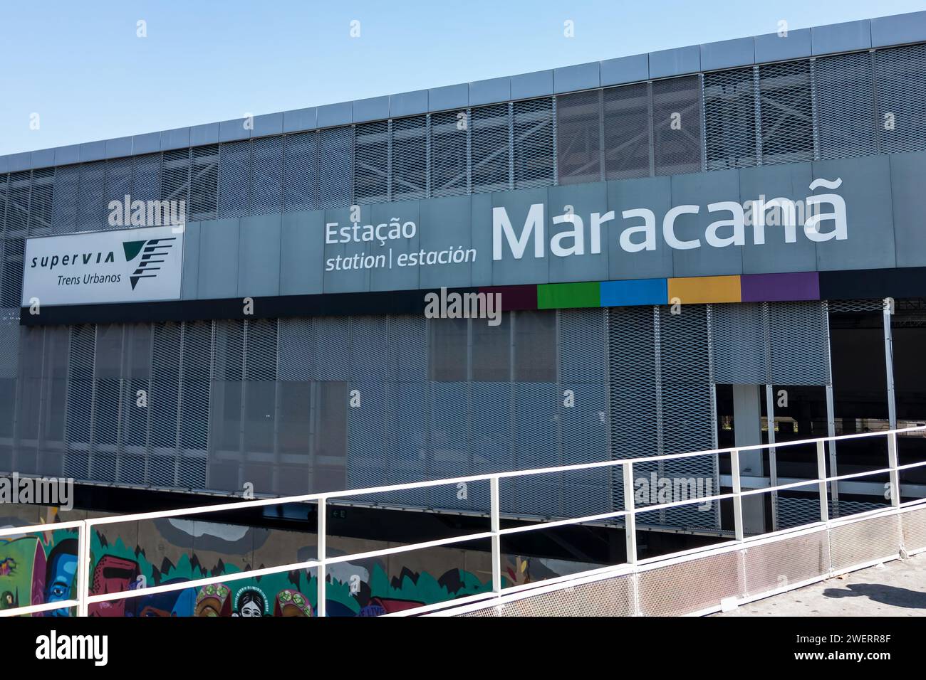 Partial view of Maracana station metal facade as saw from the station's exit pedestrian bridge in Maracana district under summer morning blue sky. Stock Photo