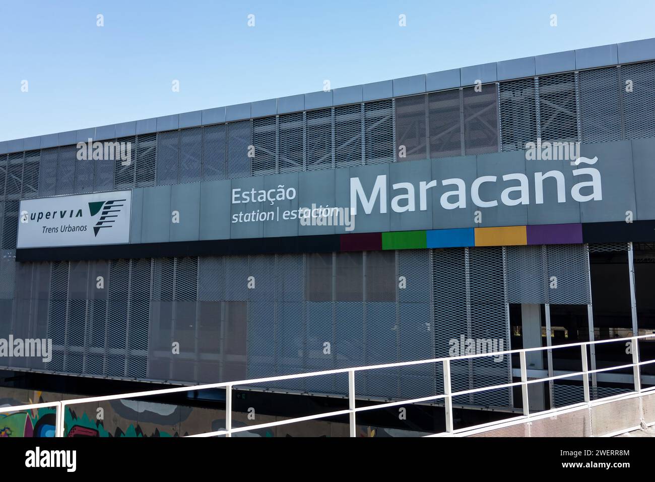Partial view of Maracana station metal facade as saw from the station's exit pedestrian bridge in Maracana district under summer morning blue sky. Stock Photo