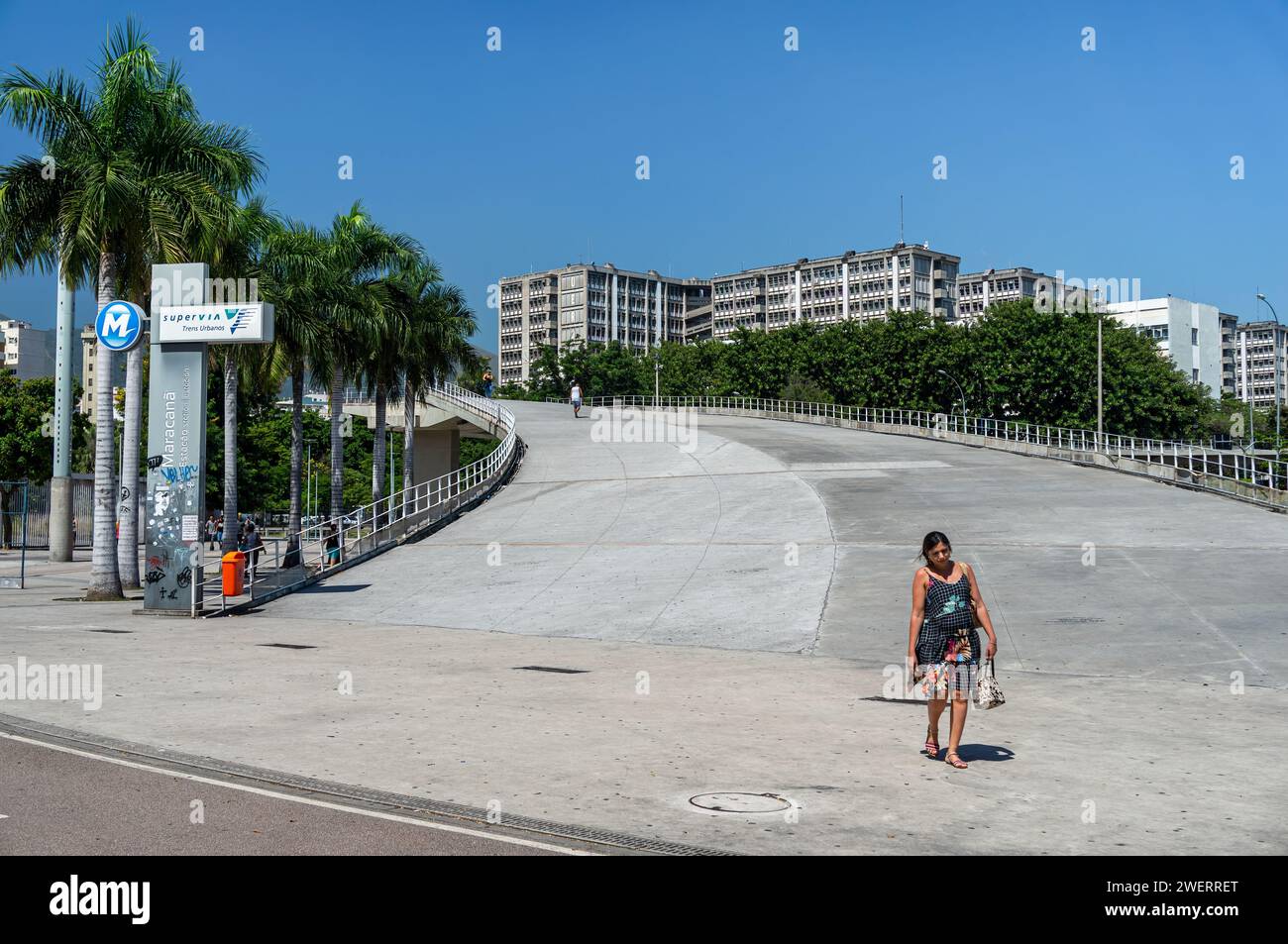 A wide footbridge ramp that links Maracana stadium to the train station of same name with partial view of Rio de Janeiro State University at the back. Stock Photo