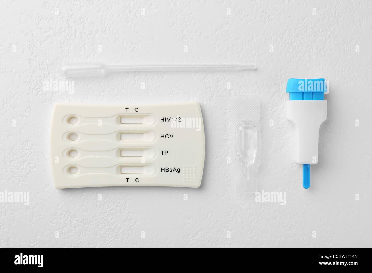 Disposable multiinfection express test kit on white table, flat lay