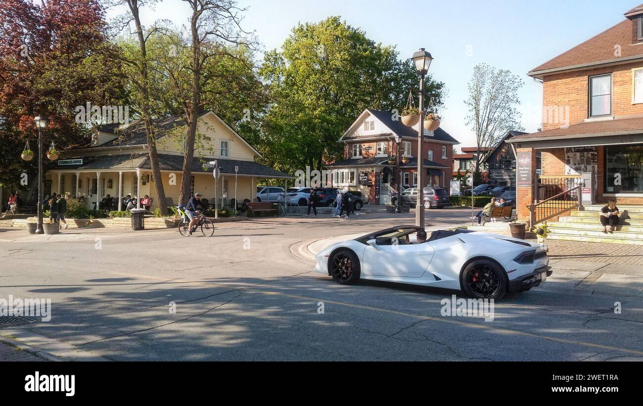 Kleinburg, Ontario, Canada - 06 02 2019: Summer evening on Islington Avenue with white Lamborghini Huracan EVO Spyder sports car in front of carefully Stock Photo