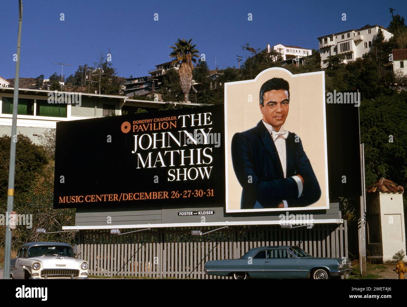 A billboard promotes a live performance by recording artist Johnny Mathis on the Sunset Strip in Los Angeles, CA, USA circa 1970s Stock Photo