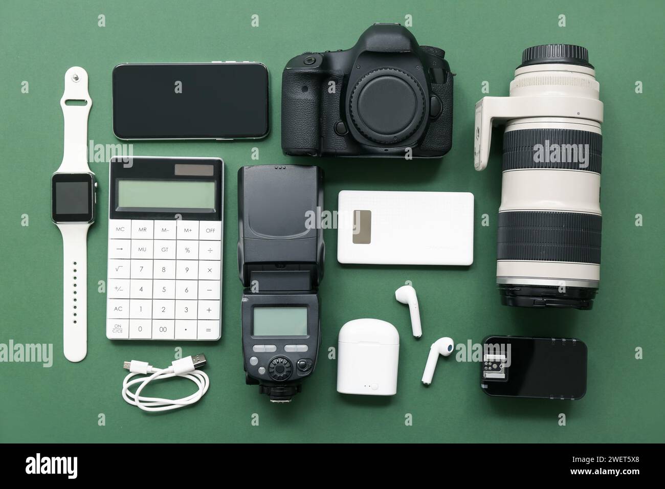 Composition with different modern gadgets on green background Stock Photo