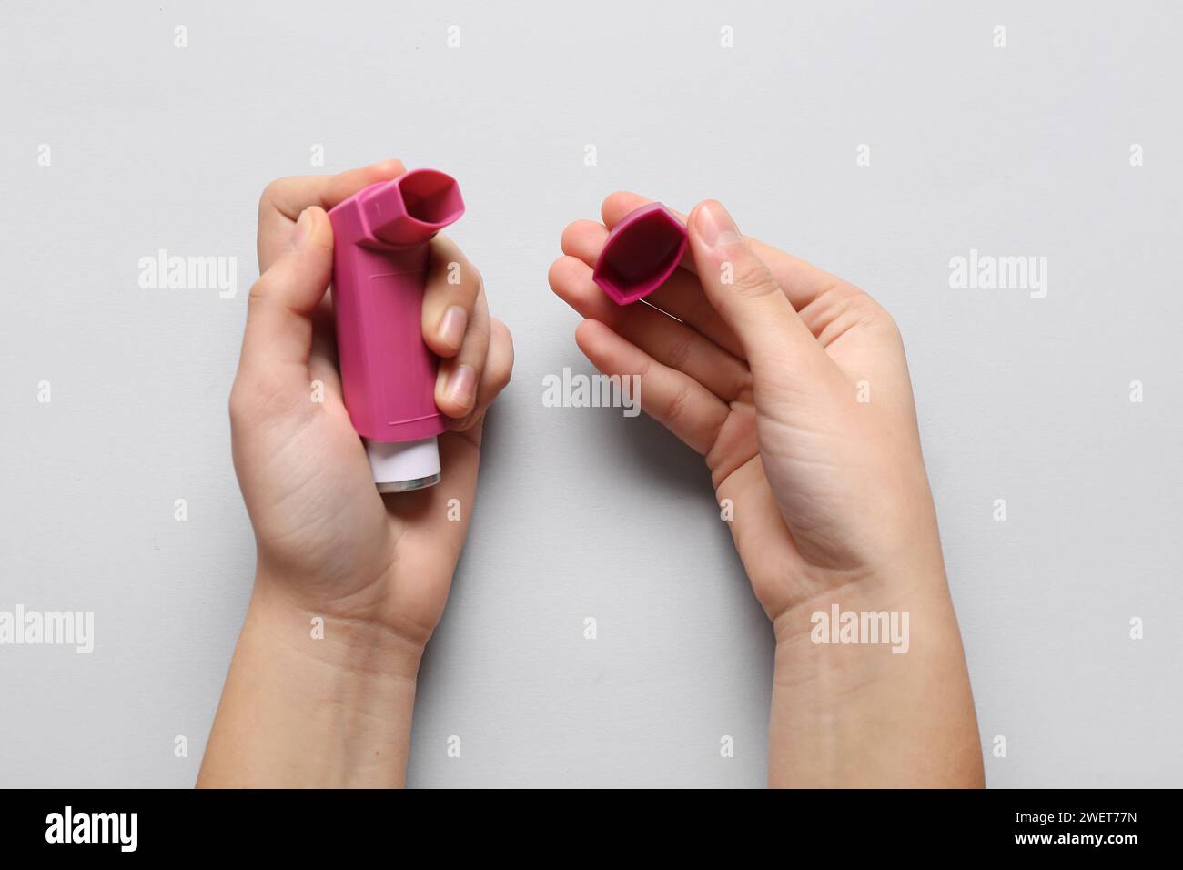 Child's hands with asthma inhaler on white background Stock Photo - Alamy