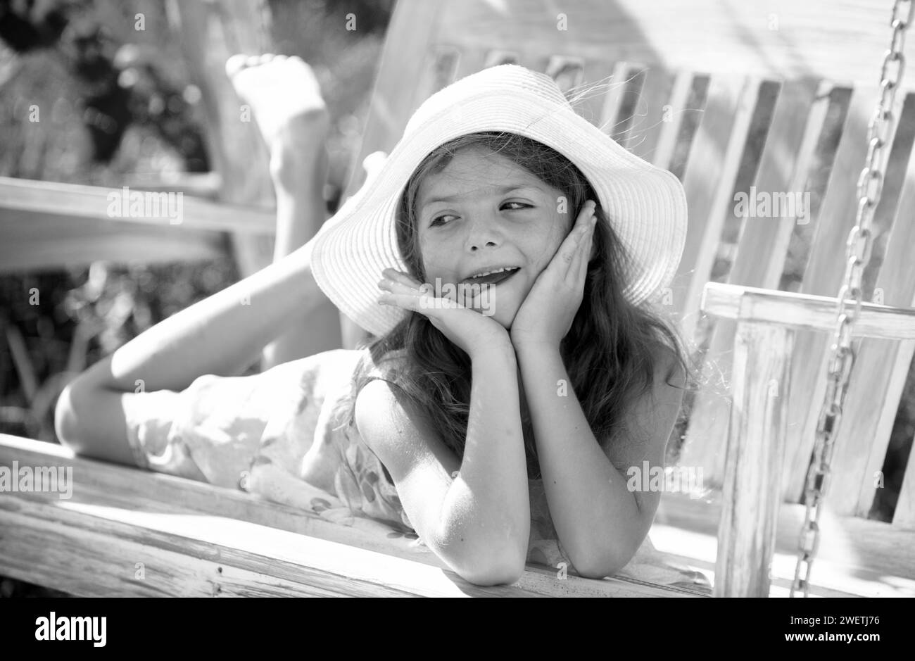 Child playing on swing. Healthy summer activity for children in warm