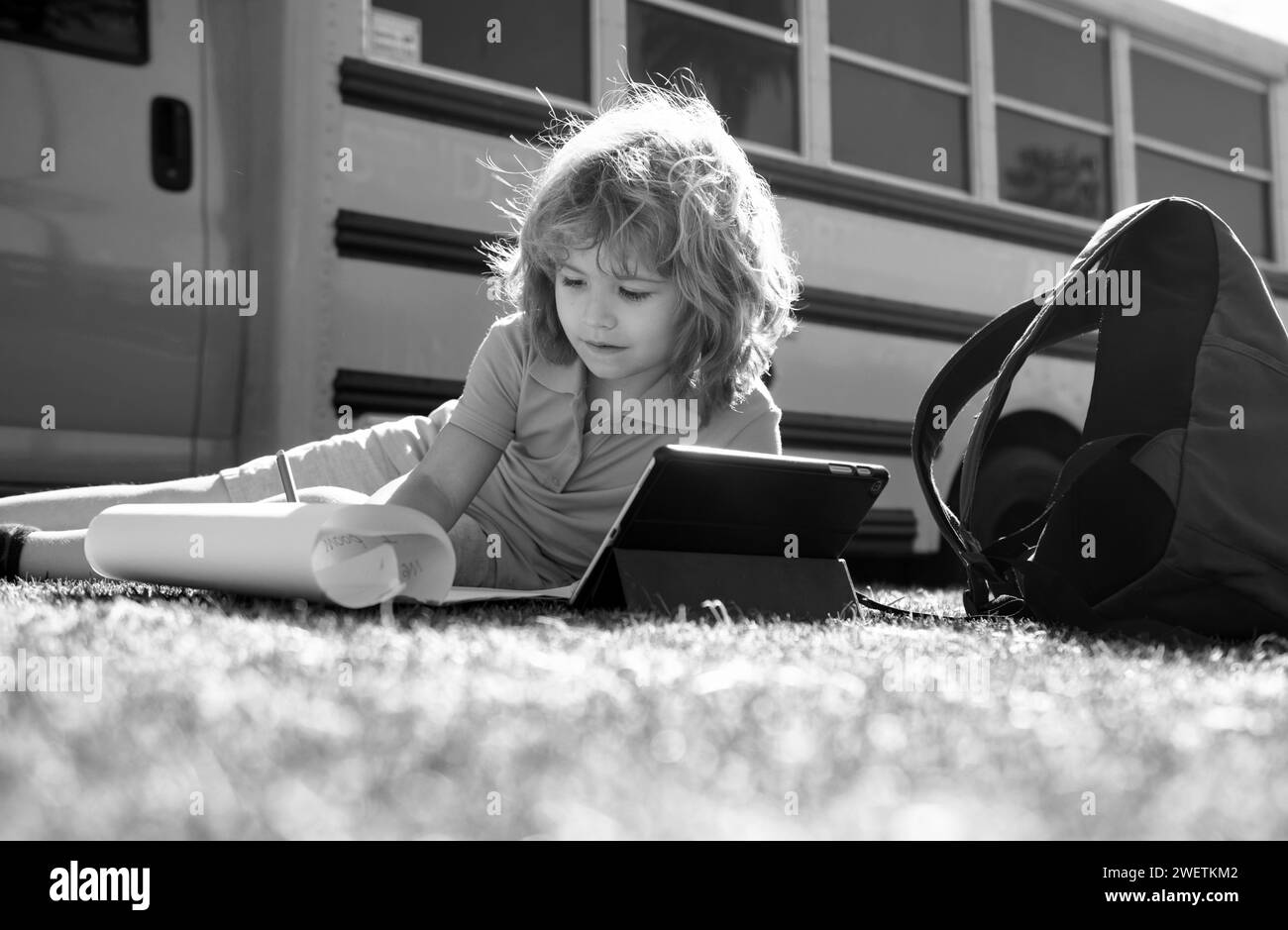 Back to school. Happy child study in park near school bus. Schoolboy ...