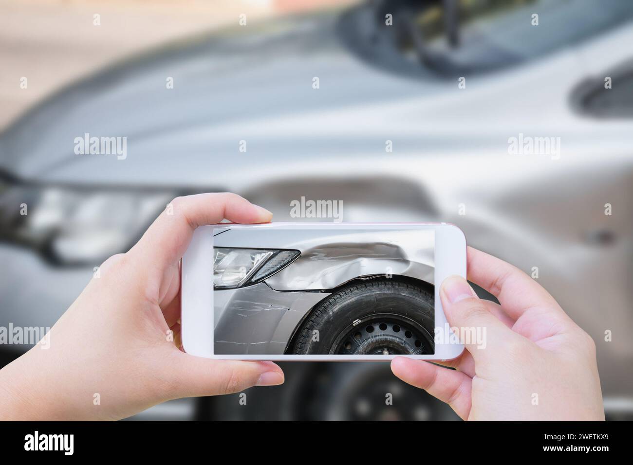 woman using mobile smartphone take photo car crash accident of the damage to the car for accident insurance Stock Photo