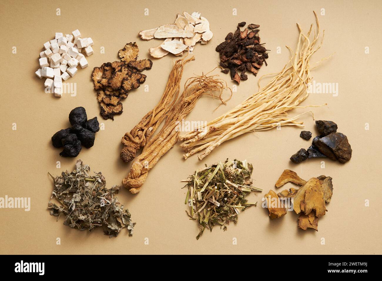 Top view of ancient Chinese herbs on light brown background. Advertising scene for health care products, derived from natural herbs Stock Photo