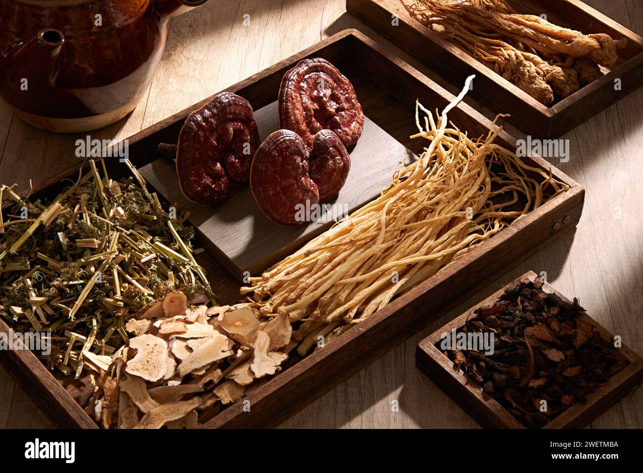 Natural, rare and healthy medicines are placed on wooden trays on brown table background. Traditional Chinese medicine is used in the prevention and t Stock Photo