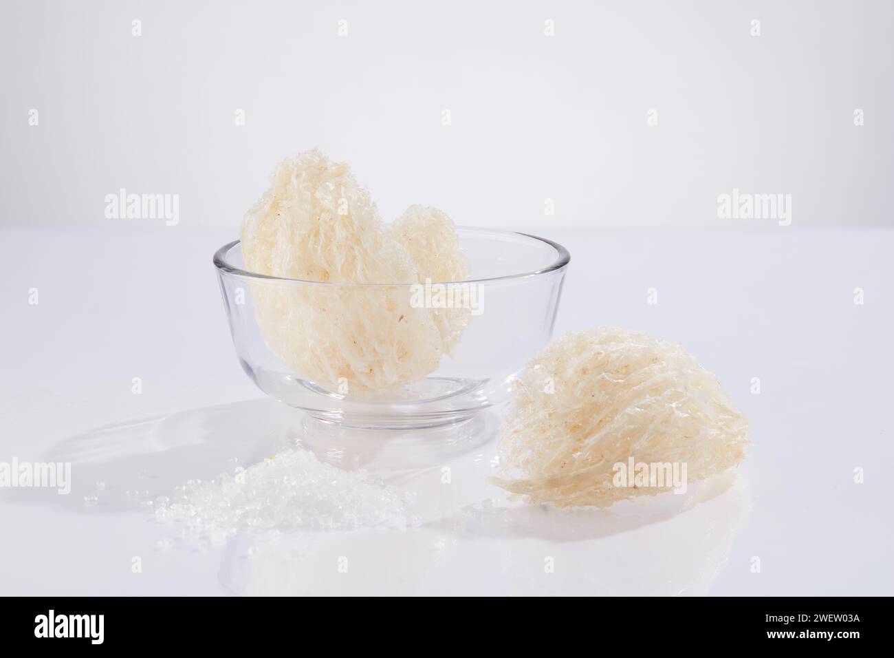 Front view of raw edible bird’s nest on glass bowl, isolated on white background. Bird's nest is