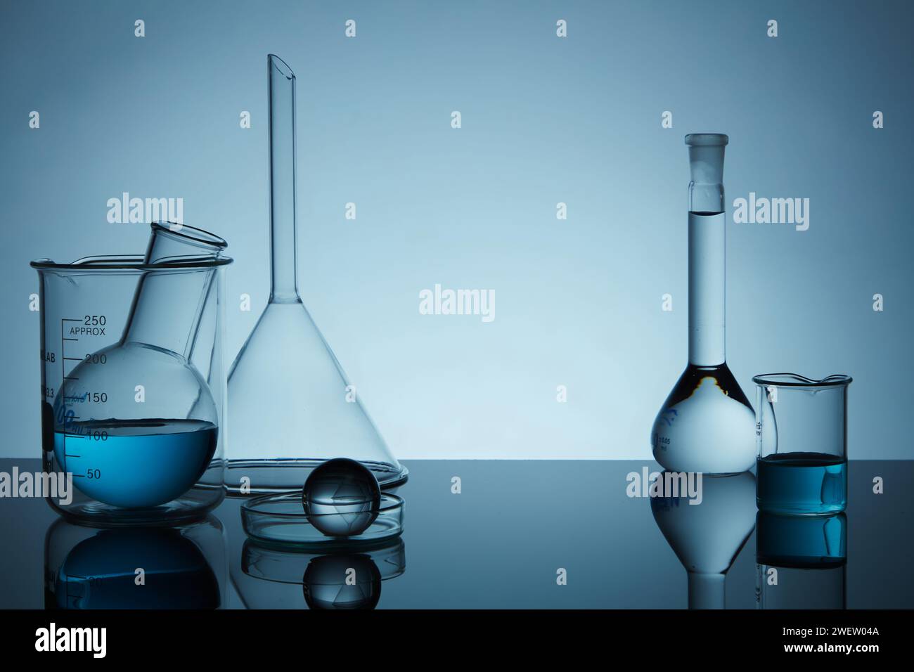Blank minimal concept with laboratory equipment filled blue liquid on