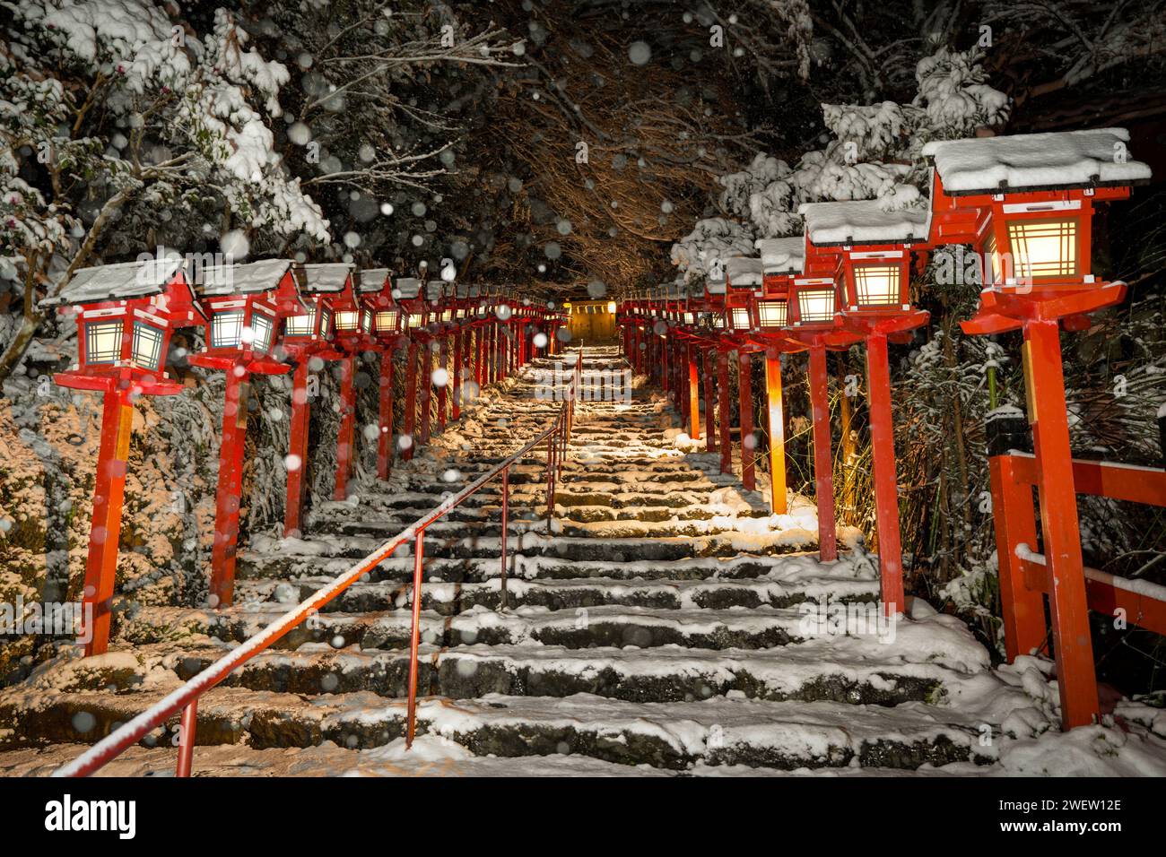 Kifune shrine stone stairs and traditional light pole in snowy winter night. Snow in Kyoto, Japan. Stock Photo