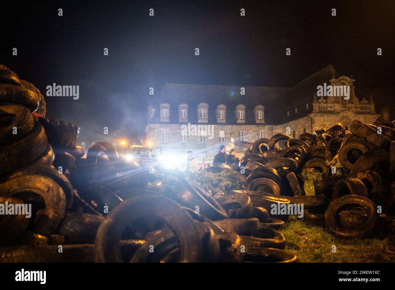 © PHOTOPQR/OUEST FRANCE/GUILLAUME SALIGOT/OUEST-FRANCE ; ; 26/01/2024 ; Plouisy (Brittany); 01/26/2024; Angry movement of farmers: farmers and in particular breeders from Côtes-d'Armor blocked the Kernilien roundabout in Plouisy (Cotes-d'Armor) near Guingamp this Friday, January 26. For the blockade, the farmers had brought many tractors with trailers full of fuel (straw, tires, waste, etc.) and lit a large fire on the roundabout. Finally and in particular, they listened together to the announcements of Prime Minister Gabriel Attal on their smartphones Stock Photo
