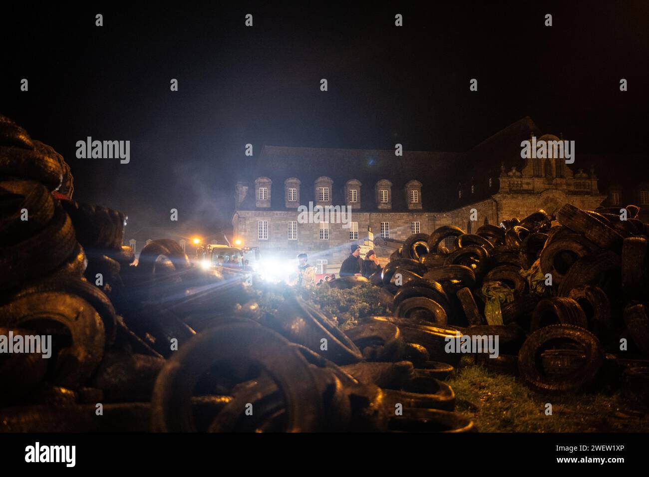 © PHOTOPQR/OUEST FRANCE/GUILLAUME SALIGOT/OUEST-FRANCE ; ; 26/01/2024 ; Plouisy (Brittany); 01/26/2024; Angry movement of farmers: farmers and in particular breeders from Côtes-d'Armor blocked the Kernilien roundabout in Plouisy (Cotes-d'Armor) near Guingamp this Friday, January 26. For the blockade, the farmers had brought many tractors with trailers full of fuel (straw, tires, waste, etc.) and lit a large fire on the roundabout. Finally and in particular, they listened together to the announcements of Prime Minister Gabriel Attal on their smartphones Stock Photo