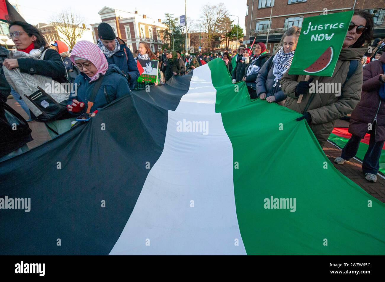 The Hague, Netherlands. 26th Jan, 2024. Large Palestinian flag and supporters, during today's International Court of Justice (ICJ) First ruling on Israel's Gaza war. The ICJ in The Hague ordered Israel on Friday to refrain from any acts of genocide against Palestinians in Gaza during its conflict with Hamas and to preserve evidence related to allegations of genocide. Credit: SOPA Images Limited/Alamy Live News Stock Photo