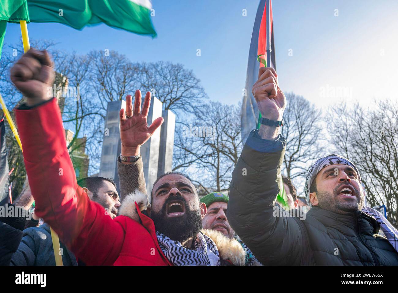 The Hague, Netherlands. 26th Feb, 2014. Palestinians with flags watch a live transmission, during today's International Court of Justice (ICJ) First ruling on Israel's Gaza war. The ICJ in The Hague ordered Israel on Friday to refrain from any acts of genocide against Palestinians in Gaza during its conflict with Hamas and to preserve evidence related to allegations of genocide. Credit: SOPA Images Limited/Alamy Live News Stock Photo