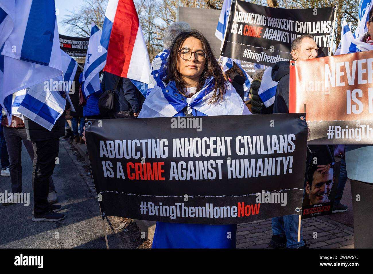 The Hague, Netherlands. 26th Feb, 2014. Israeli woman supporter with banner expressing her opinion, during today's International Court of Justice (ICJ) First ruling on Israelís Gaza war. The ICJ in The Hague ordered Israel on Friday to refrain from any acts of genocide against Palestinians in Gaza during its conflict with Hamas and to preserve evidence related to allegations of genocide. Credit: SOPA Images Limited/Alamy Live News Stock Photo