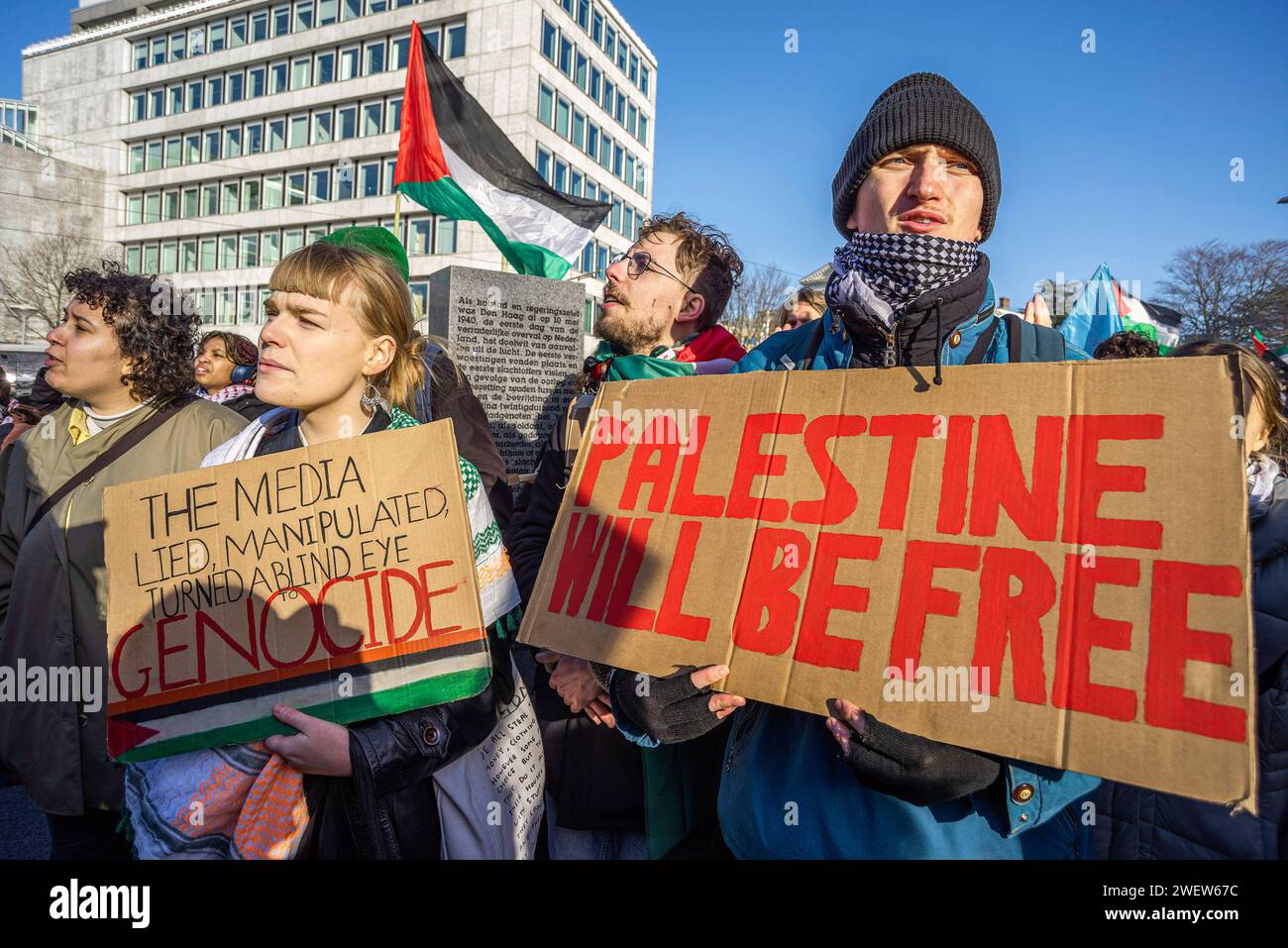 The Hague, Netherlands. 26th Feb, 2014. Two Palestinian supporters with placards and flags express their opinion, during today's International Court of Justice (ICJ) First ruling on Israel's Gaza war. The ICJ in The Hague ordered Israel on Friday to refrain from any acts of genocide against Palestinians in Gaza during its conflict with Hamas and to preserve evidence related to allegations of genocide. Credit: SOPA Images Limited/Alamy Live News Stock Photo