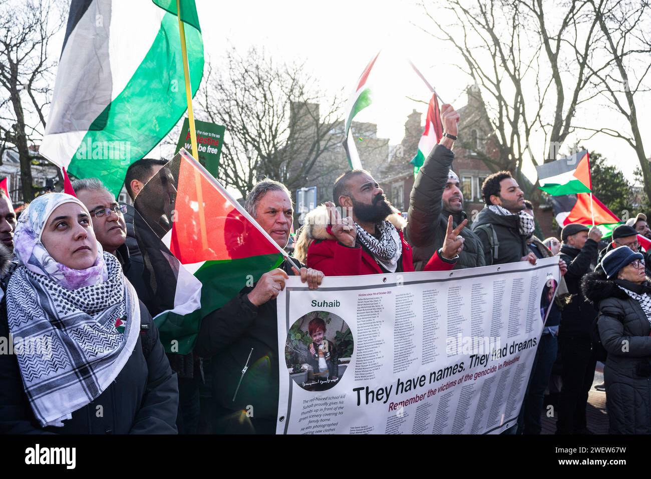 The Hague, Netherlands. 26th Feb, 2014. Palestinians with flags, and placard, watch a live transmission, during today's International Court of Justice (ICJ) First ruling on Israel's Gaza war. The ICJ in The Hague ordered Israel on Friday to refrain from any acts of genocide against Palestinians in Gaza during its conflict with Hamas and to preserve evidence related to allegations of genocide. Credit: SOPA Images Limited/Alamy Live News Stock Photo