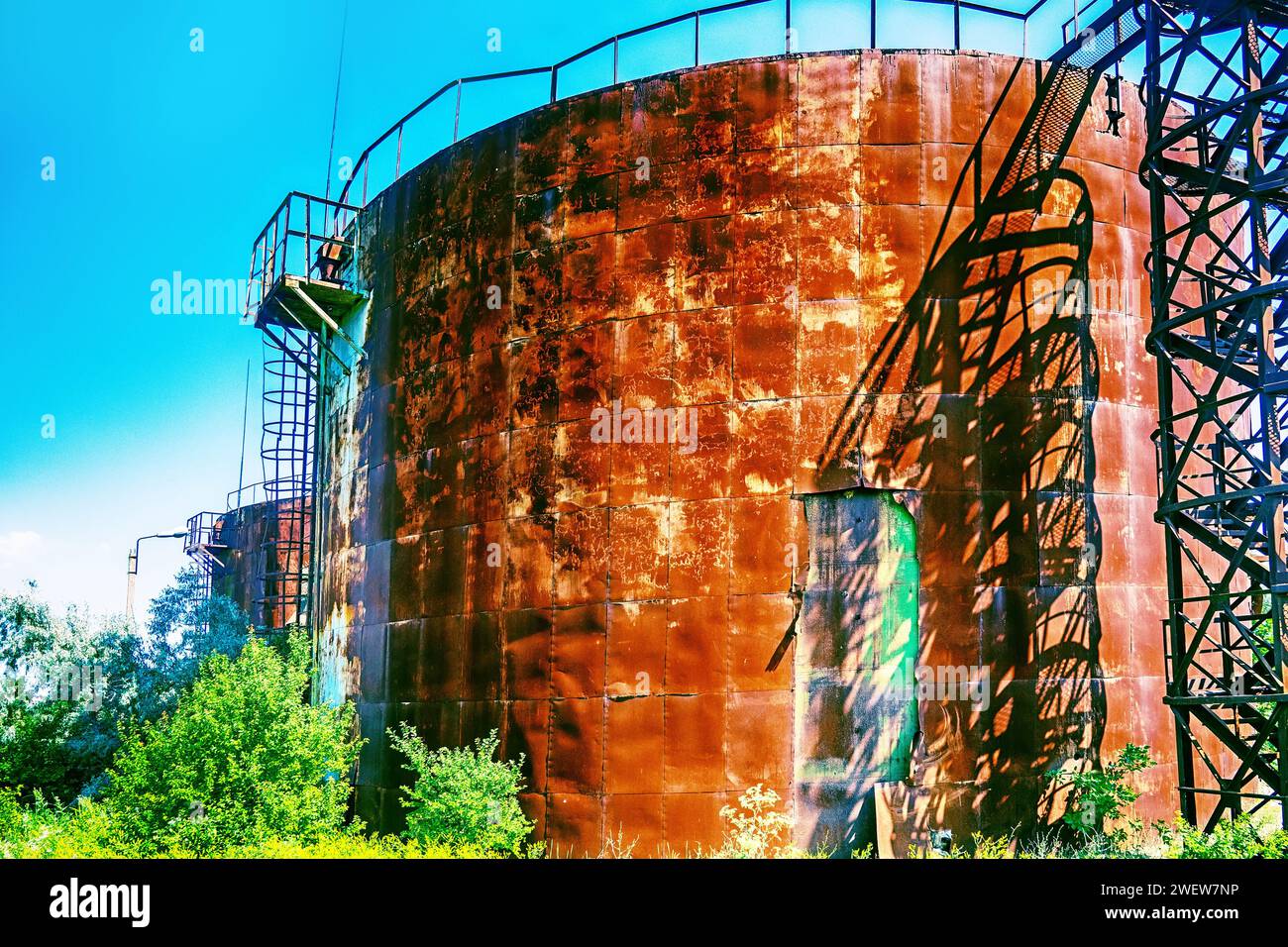 Old rusty oil tanks (fuel reservoir, oil barrel). Evidence of economic stagnation and