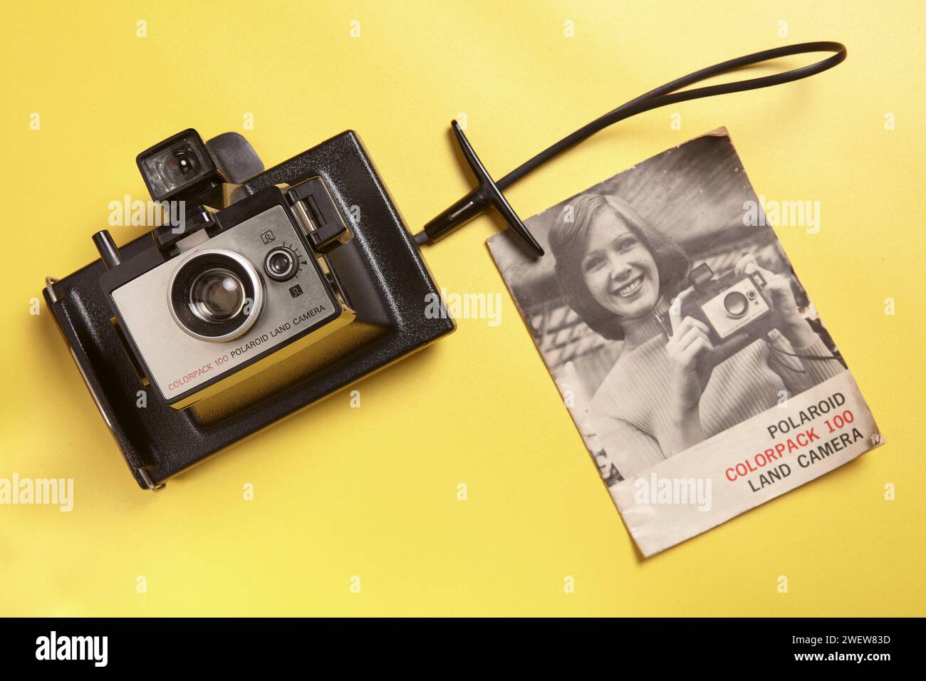A vintage Polaroid instant camera with a manual book Stock Photo Alamy