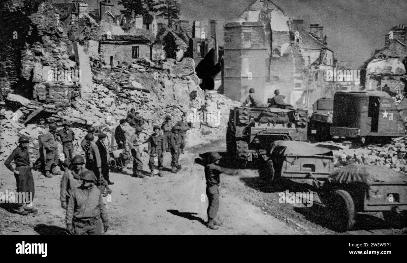 American troops pass through the ruins of a  town on the 23rd August 1944, part of the allied invasion of Europe during the Second World War. Stock Photo