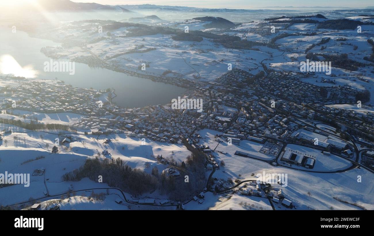 Aerial view of a sprawling mountain city bathed in sunlight Stock Photo