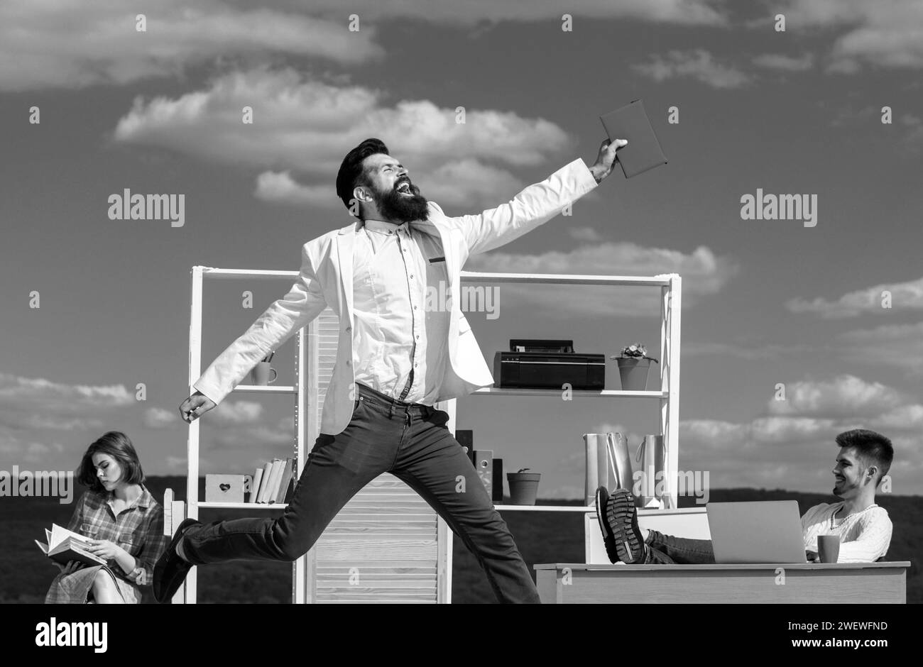 Funny businessman jump on background of colleagues. Excited office