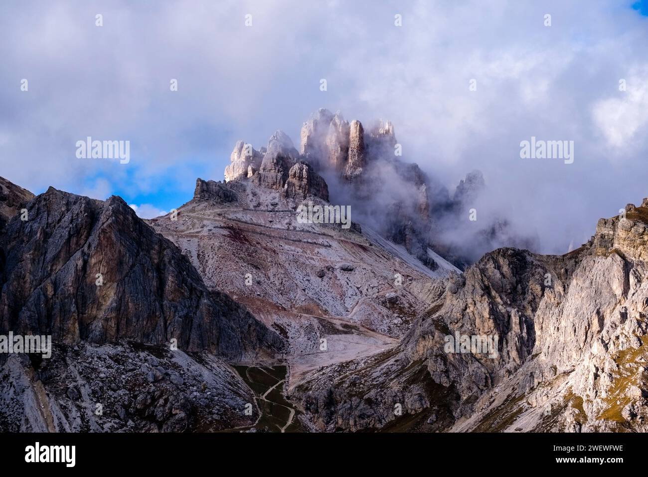 Rock faces and ridges of the mountain Grande Lagazuoi, surrounded by clouds after a rain shower in autumn. Stock Photo