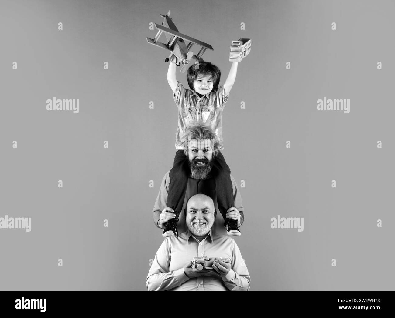 Grandfather father and son playing with toy plane. Happy man family