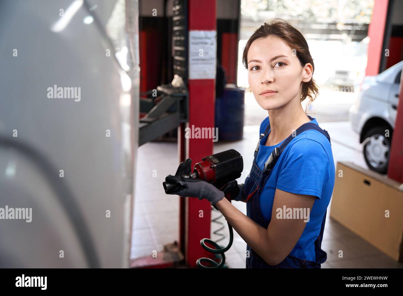 Mechanic uses pneumatic tool hi-res stock photography and images - Alamy