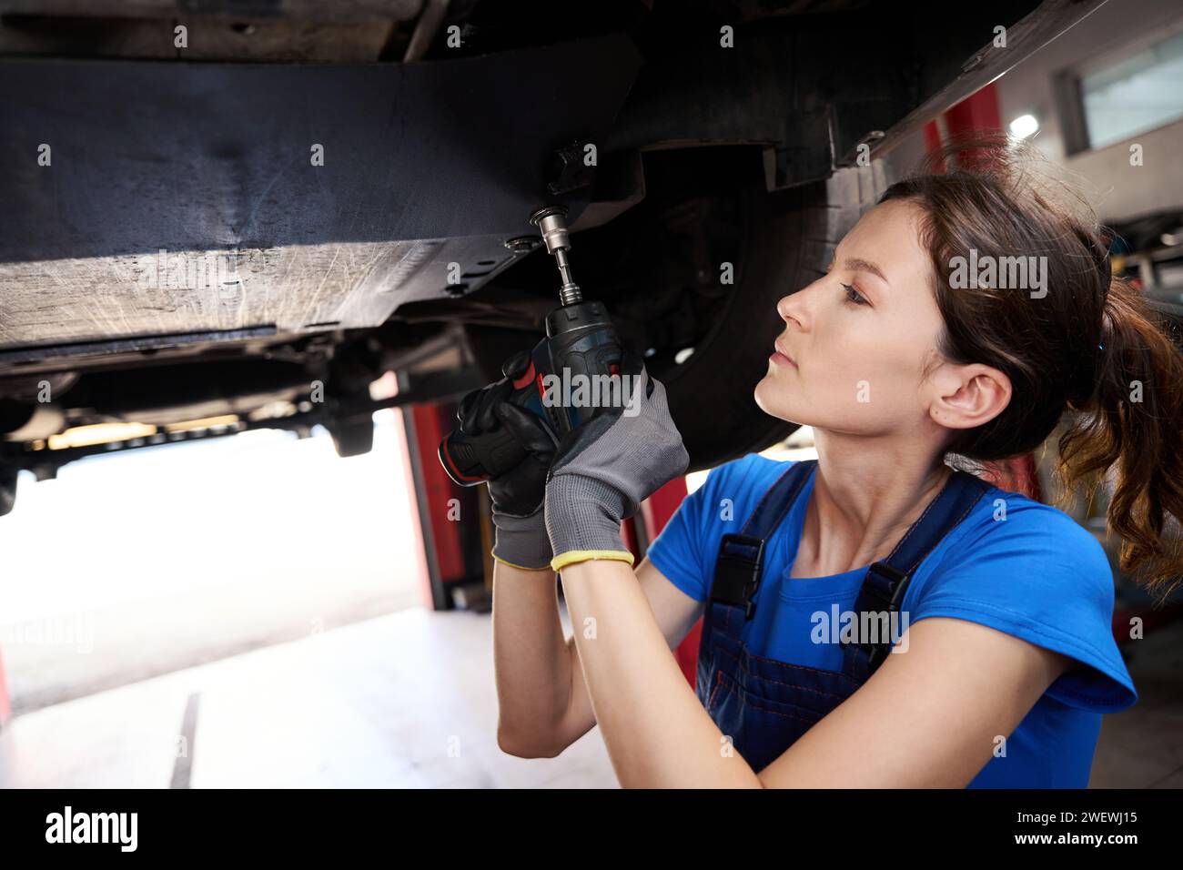 Young woman works on engine hi-res stock photography and images - Alamy